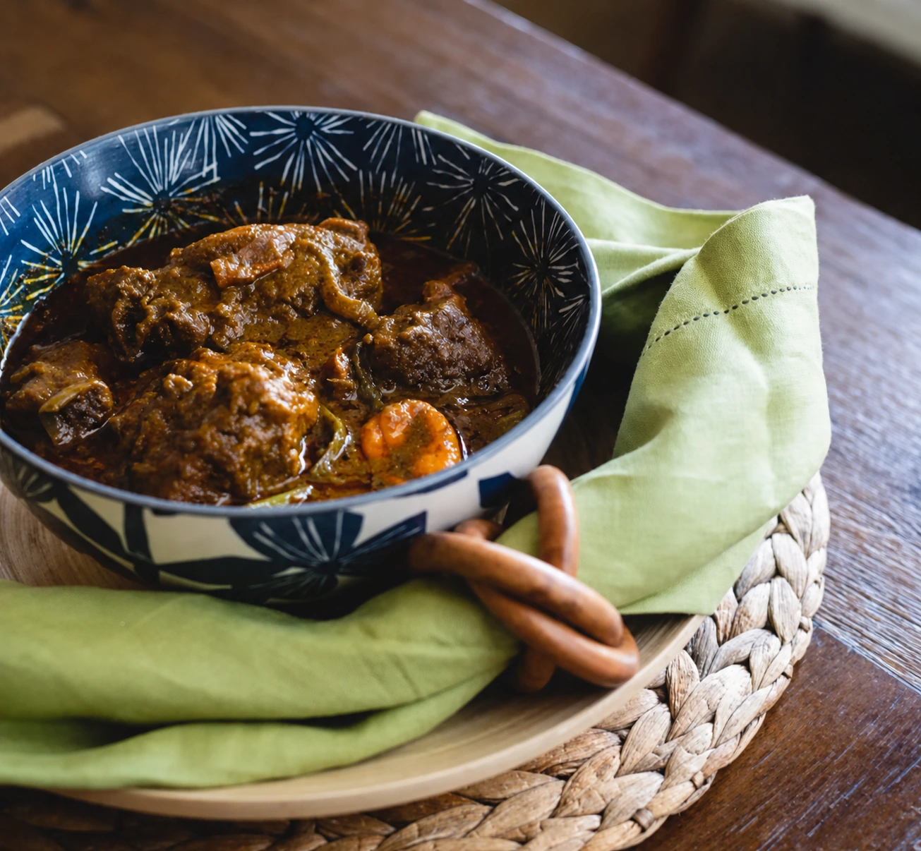 Chef Adjo's oxtail palm nut stew served in a patterned bowl